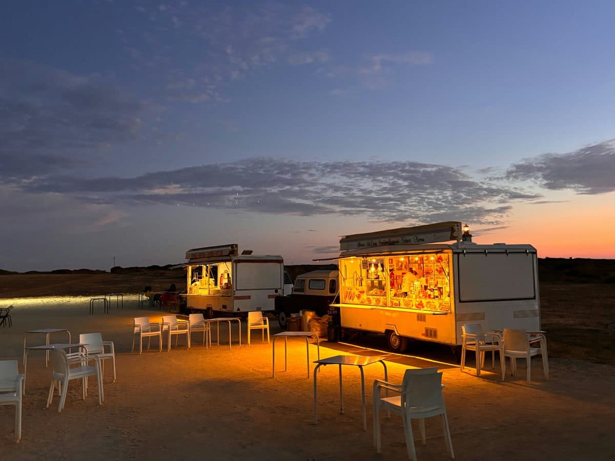 Food trucks serving guests at an outdoor evening gathering